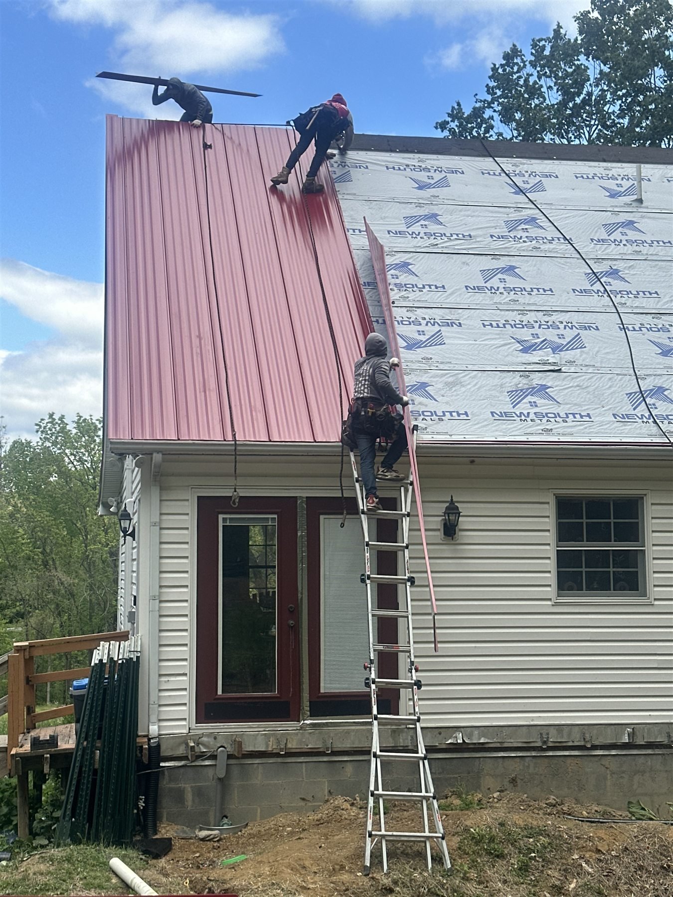 Seaman Roofing crew installing a new metal roof